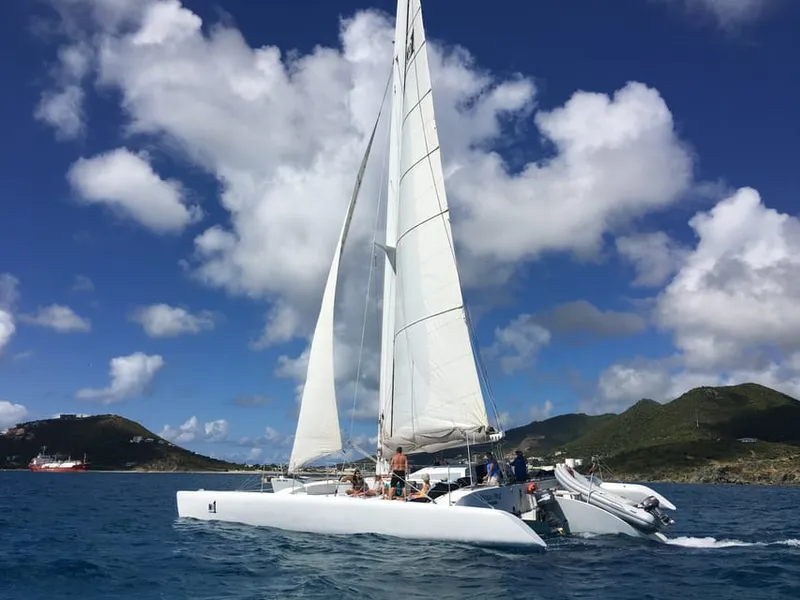 Trimaran on a Sint Maarten boat tour sailing the southwest coast with snorkelers in the clear water alongside